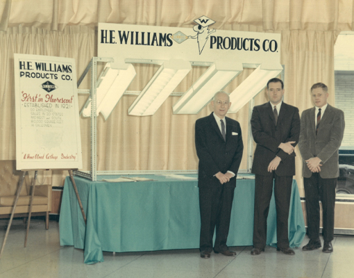 H.E. Williams and John Williams showcasing fixtures with the First in Fluorescent slogan