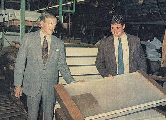John Williams and Mark Williams looking at finished fixtures on the factory floor in the 90s