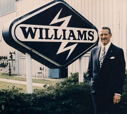 John Williams in front of the 80s Williams sign
